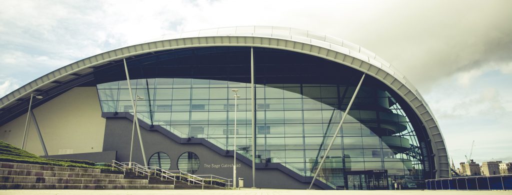 large metal building with high-arched glass paneling wall